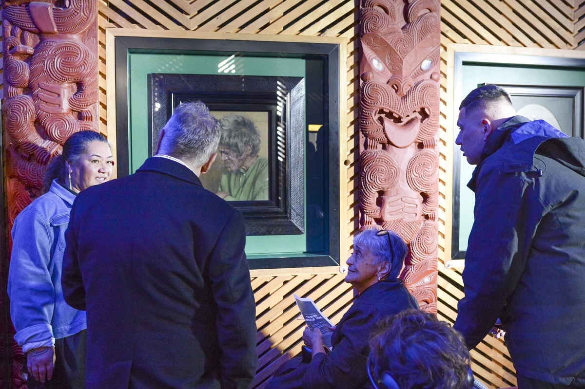 Ngatoru Wall (left), Taupō District mayor David Trewavas, Anne Erait Clarke and Tyson Taikato admire Charles Frederick Goldie’s The Blind Woman of Taupō.  