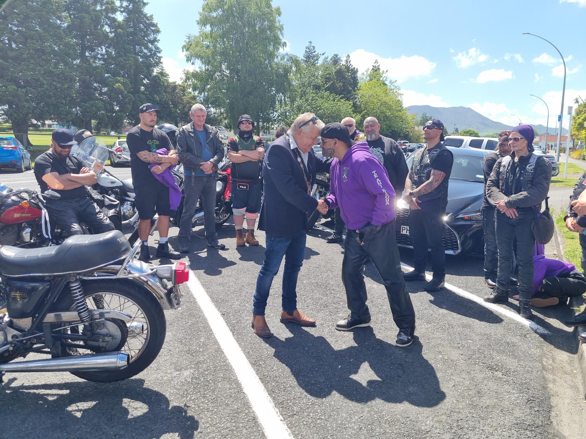 Mayor David Trewavas (left) and White Ribbon rider Takurua Tawera share a hongi outside the council chambers.  