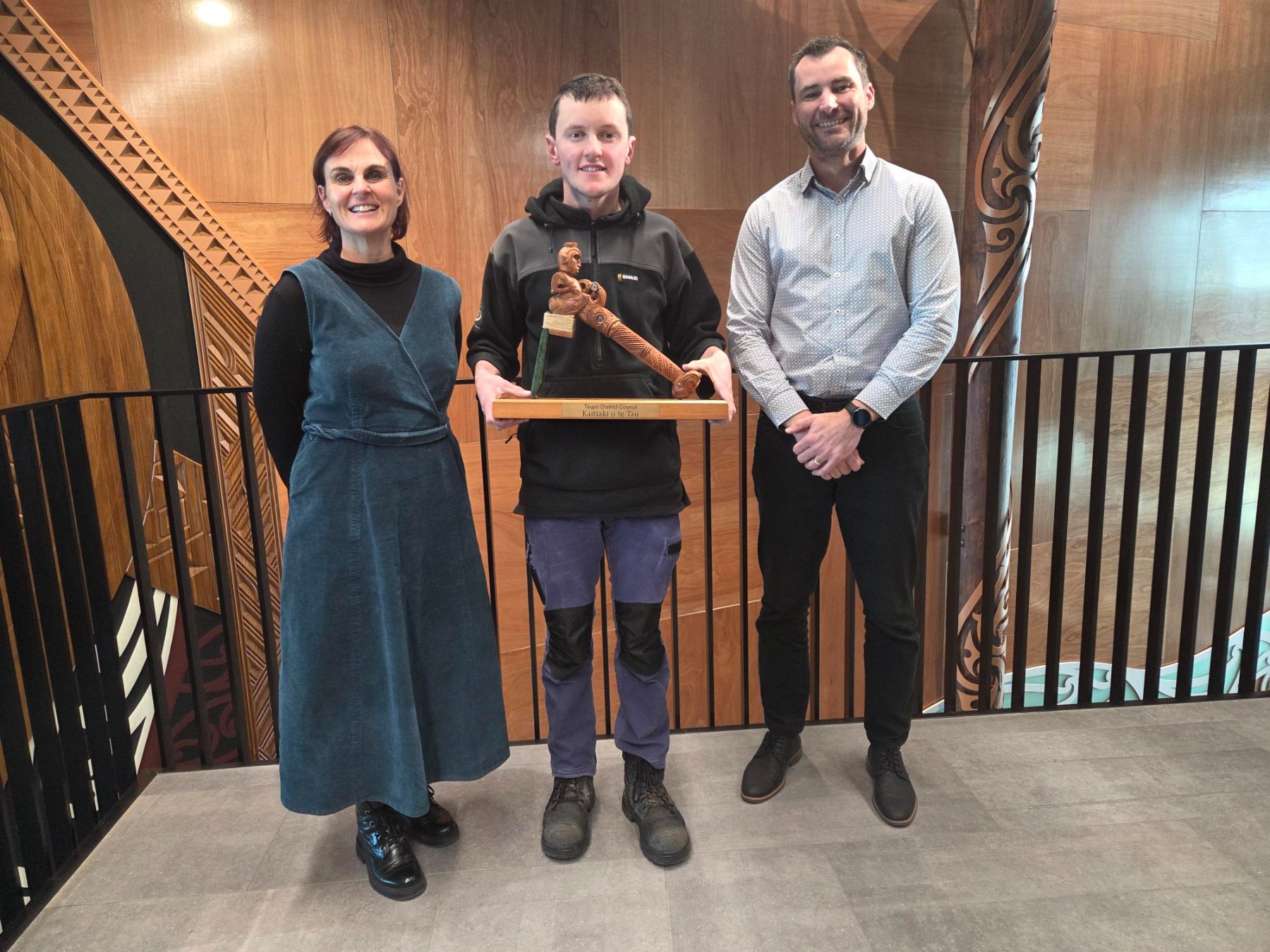 Hamish with his Te Toki trophy for Kaitaiki o te Tau, with chief executive Julie Gardyne (left) and general manager - strategy and environment Warrick Zander (right).  