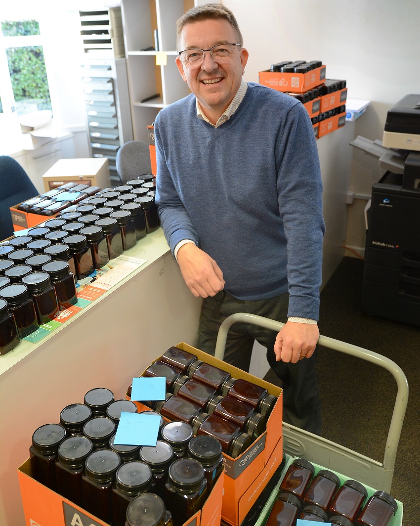 Commercial manager Flash Sandham with the honey jars.  