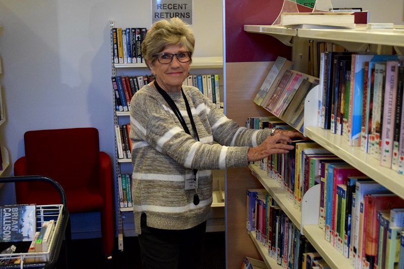 Volunteer Dawn Eskelsen shelving books at the library this week.  